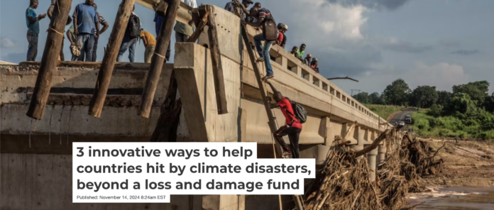 People climb to the top of a bridge damaged when Cyclone Idai hit Mozambique in 2019. Andrew Renneisen/Getty Images